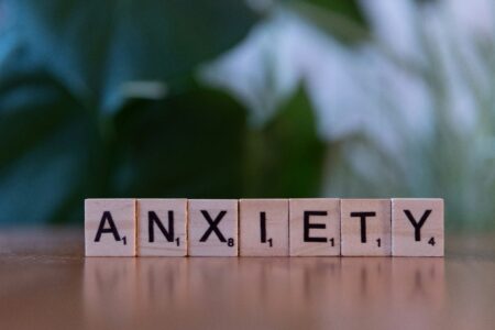 Wooden letter blocks spelling anxiety, representing mental health, stress, and emotional well-being